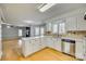 Open concept kitchen with island, stainless steel appliances, and hardwood floors at 9611 Hanover Ridge Ct, Charlotte, NC 28210