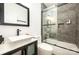 Sleek bathroom featuring a dark vanity, vessel sink, and tub/shower combo at 9706 Crooms Ct, Charlotte, NC 28215