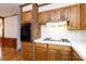 Wood kitchen cabinets and white tile countertops at 981 Meadowlark Dr, Rock Hill, SC 29732