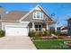 Two-story house with gray siding, white garage door, and manicured lawn at 1052 Willow Bend Dr # 51, Fort Mill, SC 29708