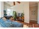 Sunlit living area features a sectional sofa, workspace, and decorative accents at 1315 East Blvd # 227, Charlotte, NC 28203