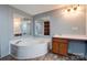 Bathroom boasts corner soaking tub and wood vanity at 2124 Mcbrayer Springs Rd, Shelby, NC 28150
