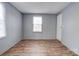 Simple bedroom with wood-look floors and gray walls at 2124 Mcbrayer Springs Rd, Shelby, NC 28150