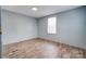 Small bedroom with wood-look floors and gray walls at 2124 Mcbrayer Springs Rd, Shelby, NC 28150
