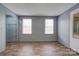 Bright living room with wood-look flooring and two windows at 2124 Mcbrayer Springs Rd, Shelby, NC 28150
