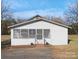 Front exterior of a white, single-story home with a covered porch at 304 Gold Hill Ave, Rockwell, NC 28138