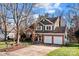 Two-story house with a green exterior, two-car garage, and a spacious driveway at 3528 Briarthorne Dr, Charlotte, NC 28269