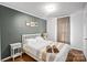 Bedroom with white bed frame, gray walls, and a side table at 357 Stillwater Rd, Troutman, NC 28166