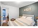 Bedroom with white bed frame, gray walls, and access to another room at 357 Stillwater Rd, Troutman, NC 28166