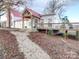 Charming farmhouse with red metal roof, large deck, and landscaped yard at 3703 Old Pageland Marshville Rd, Wingate, NC 28174