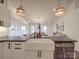 Modern farmhouse kitchen with white cabinets, apron sink, and large island at 3703 Old Pageland Marshville Rd, Wingate, NC 28174