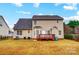 House's back view, showcasing a deck and a spacious yard at 417 Stowe Rd, Belmont, NC 28012