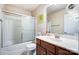 Bathroom with tub, shower, and vanity with wood cabinets at 417 Stowe Rd, Belmont, NC 28012