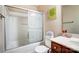 Bathroom with tub, shower, and vanity with wood cabinets at 417 Stowe Rd, Belmont, NC 28012