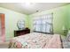 Bedroom with floral bedding, dresser, and window with curtains at 417 Stowe Rd, Belmont, NC 28012