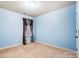 Light blue bedroom with one window, carpet, and neutral decor at 417 Stowe Rd, Belmont, NC 28012