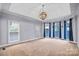 Bright bedroom with bay windows, plush carpeting, and a ceiling fan at 5300 Haynes Hall Pl, Charlotte, NC 28270