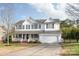 Two-story house with white siding, black shutters, and a double garage at 5614 Underwood Ave, Charlotte, NC 28213