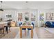 Modern dining area with light wood table and blue velvet chairs; open to kitchen at 1479 Earl St, Hickory, NC 28602