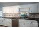 Kitchen with white cabinets, granite countertops and tile backsplash at 2051 Gary Ln, Hickory, NC 28602