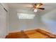 Light-blue bedroom with hardwood floors and a ceiling fan at 236 Sidesmur Ne Ct, Concord, NC 28025