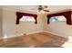 Spacious bedroom with hardwood floors and burgundy curtains at 236 Sidesmur Ne Ct, Concord, NC 28025