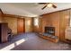 Cozy living room featuring a brick fireplace and wood paneled walls at 236 Sidesmur Ne Ct, Concord, NC 28025