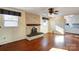 Living room with hardwood floors, fireplace and kitchen view at 236 Sidesmur Ne Ct, Concord, NC 28025