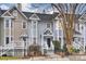 Three charming townhouses with unique pastel exteriors and front porches at 314 W 10Th St, Charlotte, NC 28202