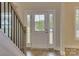 Front entry door with a four-light glass panel at 316 Coronado Ave, Matthews, NC 28104