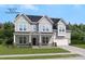 Two story house with gray siding, white trim, and a three car garage at 316 Coronado Ave, Matthews, NC 28104