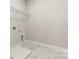 Convenient laundry room with built-in shelving and marble-look tile at 316 Coronado Ave, Matthews, NC 28104