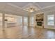 Spacious living room with stone fireplace and hardwood floors at 316 Coronado Ave # 040, Matthews, NC 28104