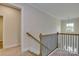 Upstairs hallway with open railing and neutral paint colors at 316 Coronado Ave, Matthews, NC 28104