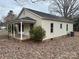 Exterior view of a one-story home with a covered porch and a yard covered in fall leaves at 321 Corriher Heights Ave, China Grove, NC 28023