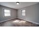 Well-lit bedroom with hardwood floors and two windows at 3210 Puetts Chapel Rd, Dallas, NC 28034