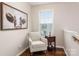 Quiet sitting area with comfy chair and hardwood floors, near staircase at 3307 Tempo Ln, Indian Land, SC 29707