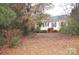 House exterior view from the backyard with mature trees and landscaping at 419 Clay St, Mooresville, NC 28115