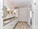 Elegant bathroom with double vanity, grey countertops, and large mirrors at 4720 Aspen Ct, Charlotte, NC 28210