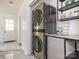 Modern laundry room with stacked washer and dryer, and ample shelving at 6833 Charette Ct, Charlotte, NC 28215