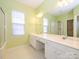 Double vanity bathroom with large mirror and walk-in shower at 8517 Condor Cir, Charlotte, NC 28269