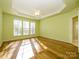 Large main bedroom with hardwood floors, ceiling fan, and multiple windows at 8517 Condor Cir, Charlotte, NC 28269