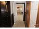 View of a hallway with doors leading to other rooms and a glimpse of the kitchen at 1003 Camden Rd, Wadesboro, NC 28170