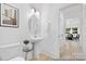 Modern powder room with pedestal sink, oval mirror, and stylish accents at 1105 Alyssa Oaks Dr # 47, Lowell, NC 28098