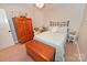 Bedroom featuring a wooden armoire, a ceiling fan, and neutral decor at 1156 13Th Avenue Ne Cir, Hickory, NC 28601