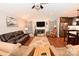 Living room with a fireplace, leather furniture, wood floors, and vaulted ceiling at 1156 13Th Avenue Ne Cir, Hickory, NC 28601