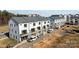 Aerial view of modern townhouses with attached garages and surrounding landscape at 13005 Moon Rd # 43, Charlotte, NC 28277