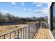 Private balcony overlooking a wooded area, with a view of a pond at 13005 Moon Rd # 43, Charlotte, NC 28277