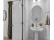 Simple and elegant bathroom with pedestal sink and round mirror at 13005 Moon Rd # 43, Charlotte, NC 28277