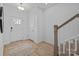 Bright and airy entryway with light wood floors, a rug, and staircase at 13005 Moon Rd # 43, Charlotte, NC 28277